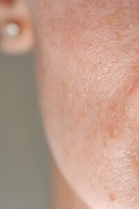 Detailed close-up of human skin showing natural pores and texture, highlighting real beauty.